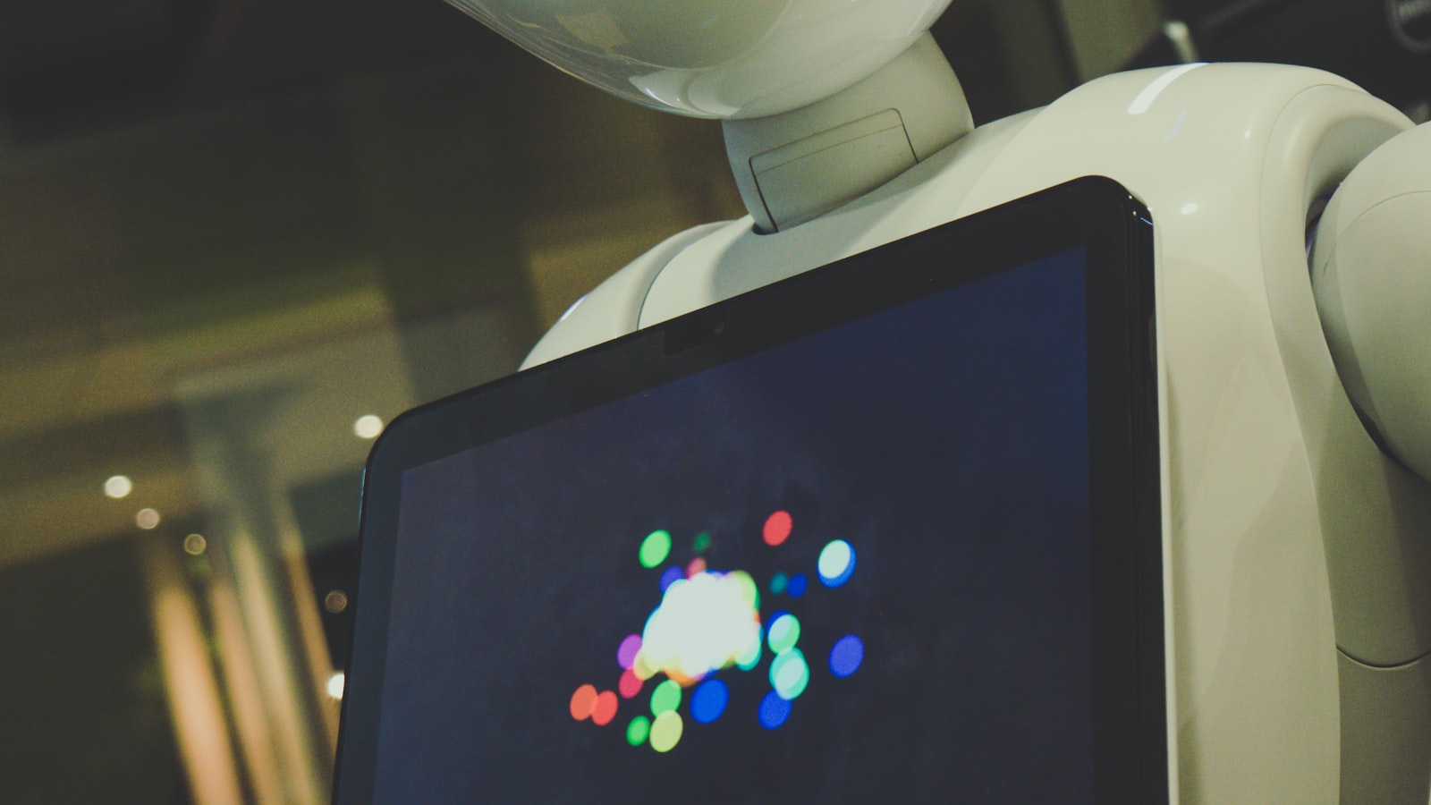 A humanoid robot holding a tablet, representing conversational AI
