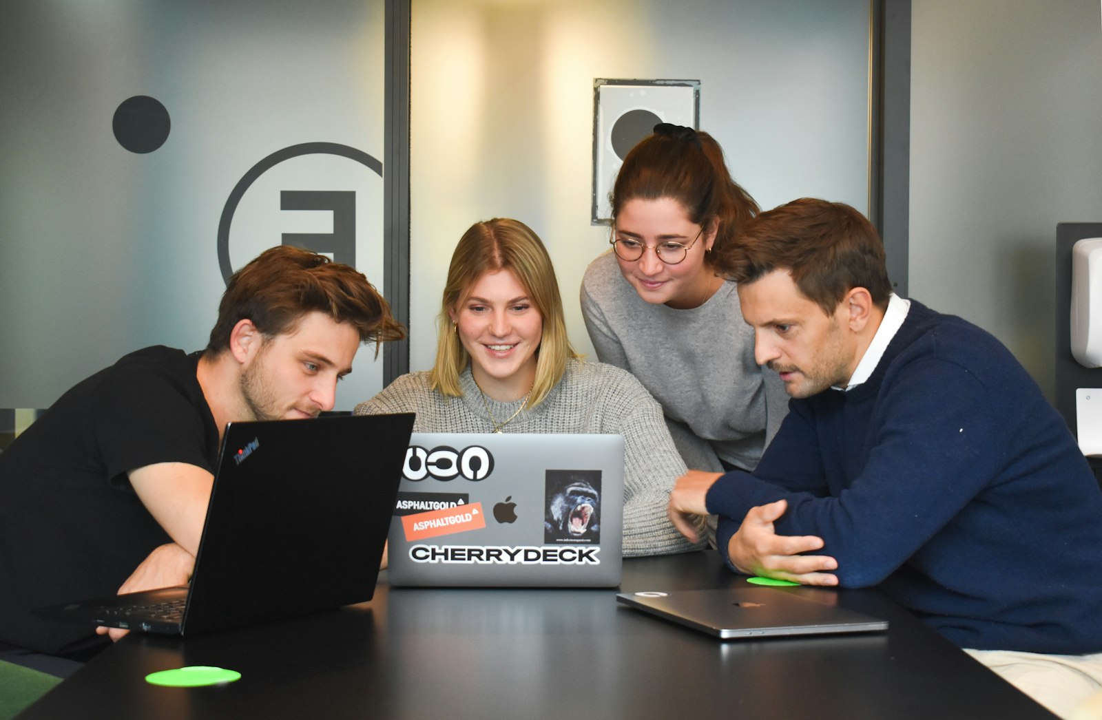 A team mapping out project scope around a laptop